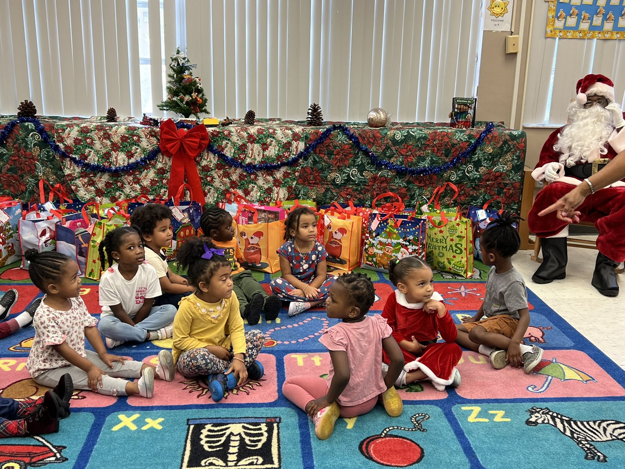 Children receiving Christmas gifts at a My Safe Harbor holiday event