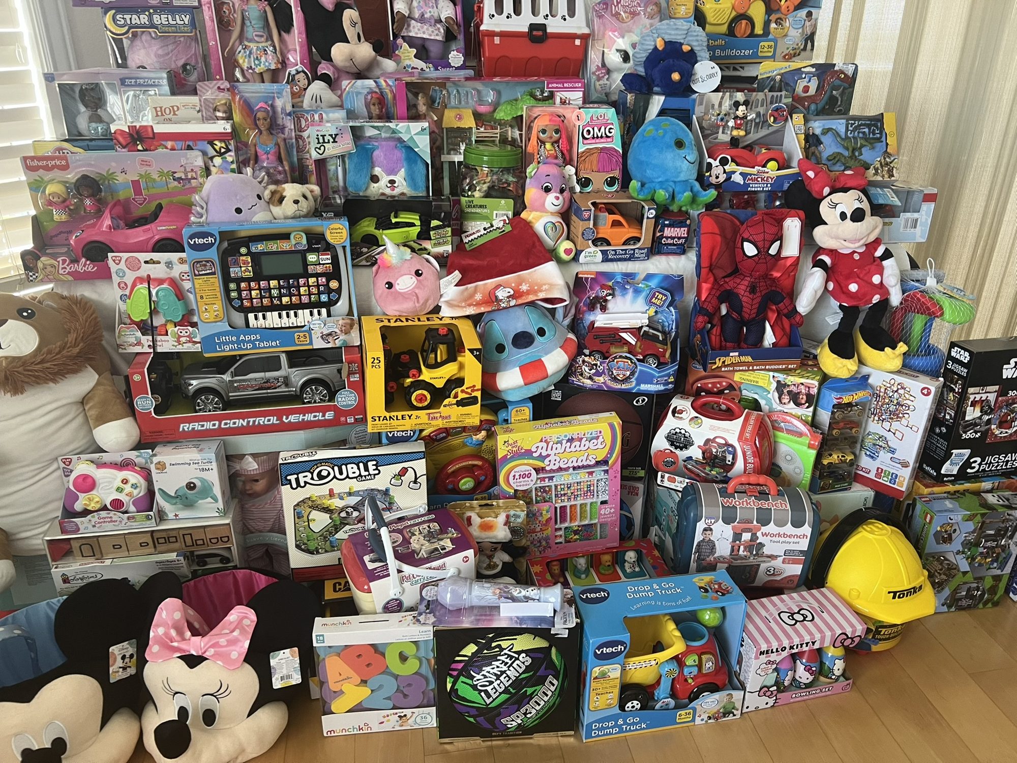 Large pile of donated toys, plush characters and games